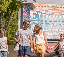 Family walking in front or Eumundi market sign