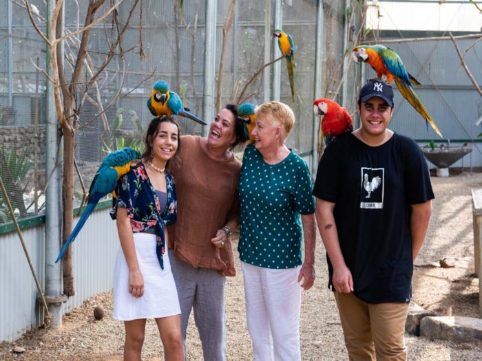 A family with birds on their heads at Bird World