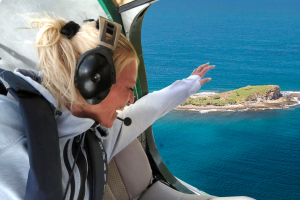 Woman flying with doors off in seaplane over Mudjimba Island